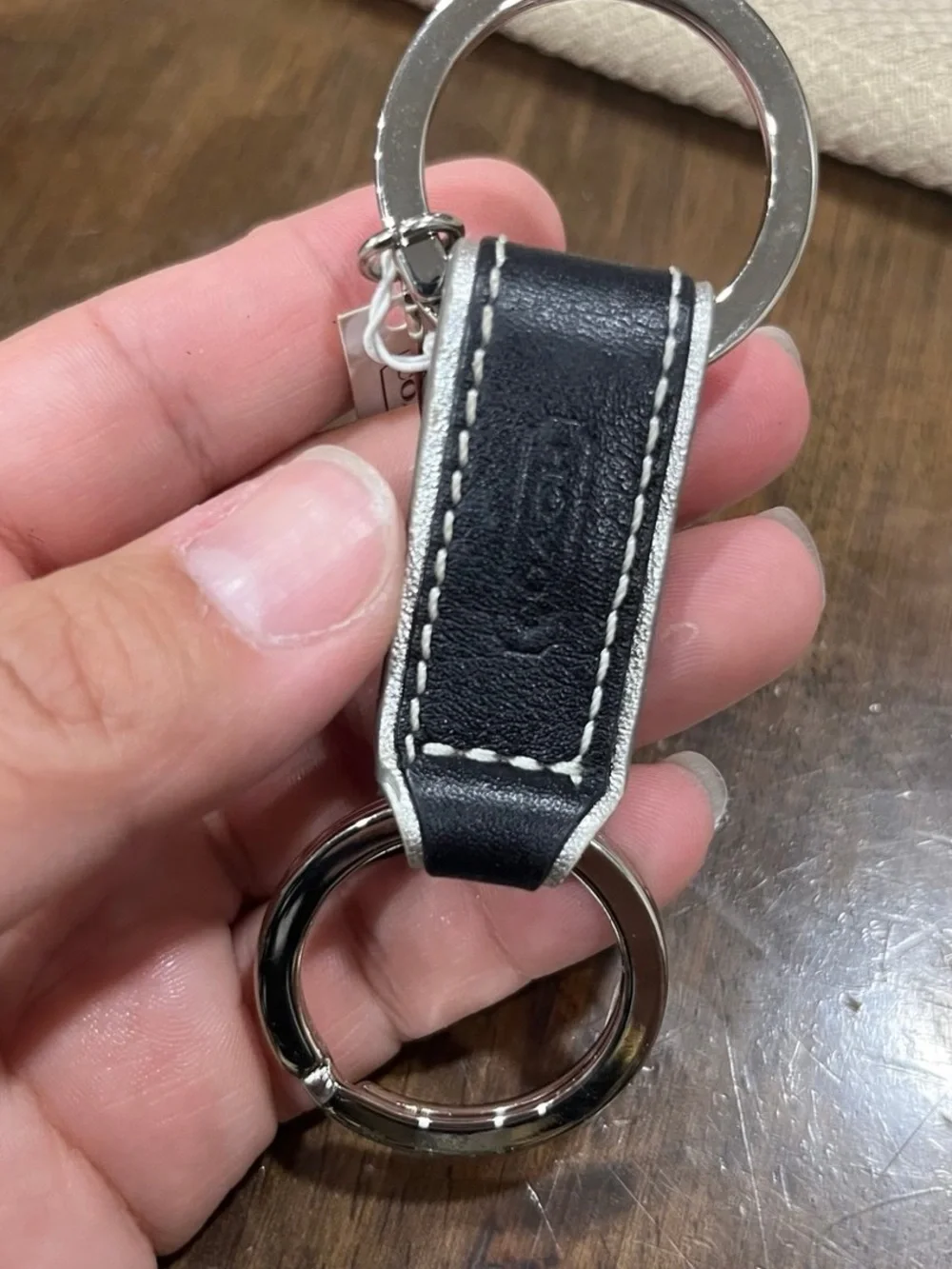 Coach black leather valet keychain.